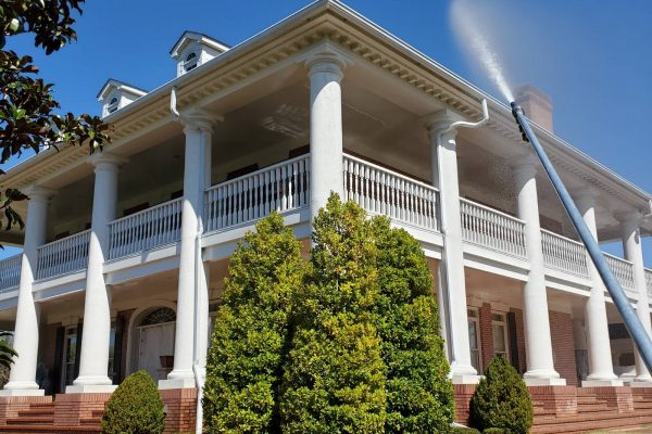 House Washing A massive property with a balcony being professionally soft washed